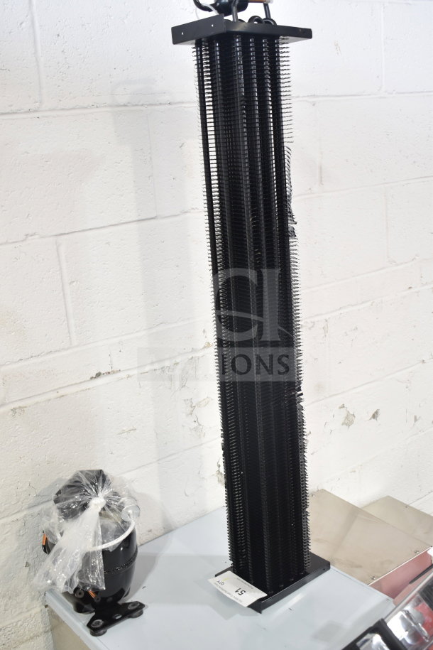 BRAND NEW SCRATCH AND DENT KoolMore evaporator coil, black finish, visible small dents, tagged with item number 51.