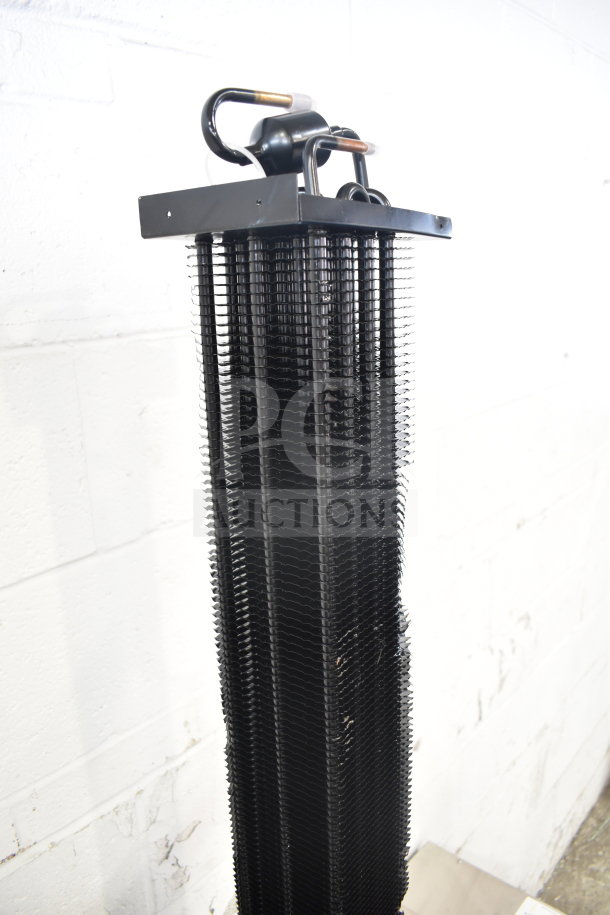 BRAND NEW SCRATCH AND DENT KoolMore evaporator coil, black, vertical design, visible copper connectors.