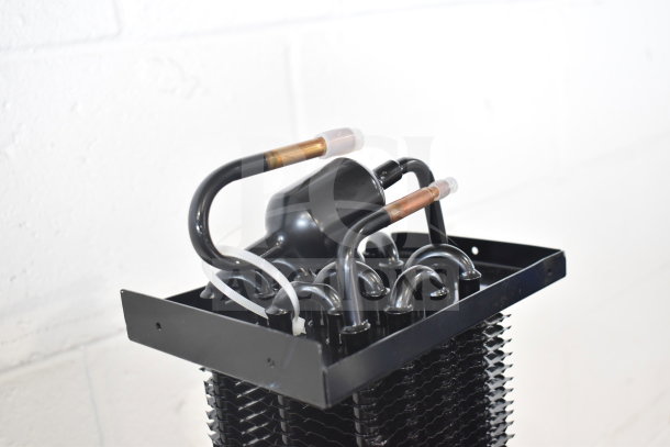 Brand new KoolMore evaporator coil, scratch and dent condition, featuring black metal tubing and fins.