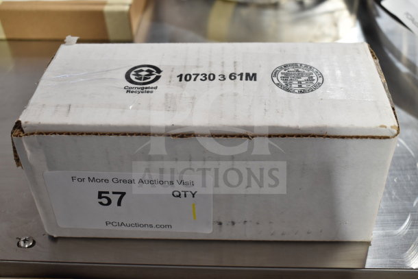 Box containing brand new Heatcraft 25317801 evaporator motor with minor scratches. Label shows auction and recycling info.