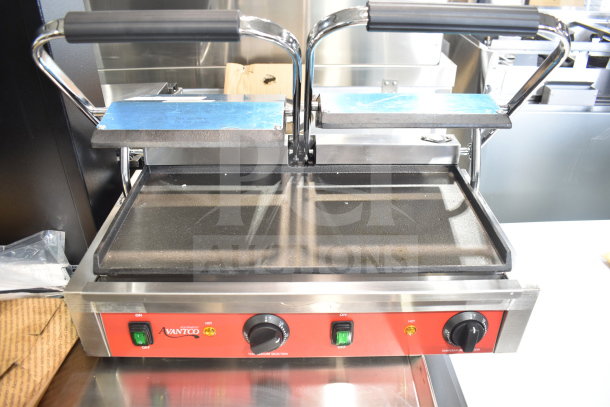Brand new Avantco 177PG400S commercial dual panini grill with smooth plates, 19 5/8" x 9 1/8" cooking surface.