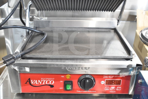 Brand new Avantco 177PG200GST commercial panini grill with timer, grooved top, smooth bottom, 13 3/8" x 8 3/4" surface.