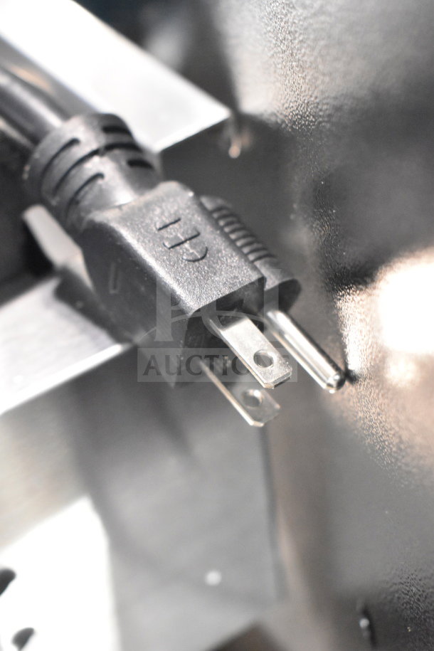Close-up of Avantco Panini Grill 177PG200GST power plug, showing three-prong configuration and part of metal casing.