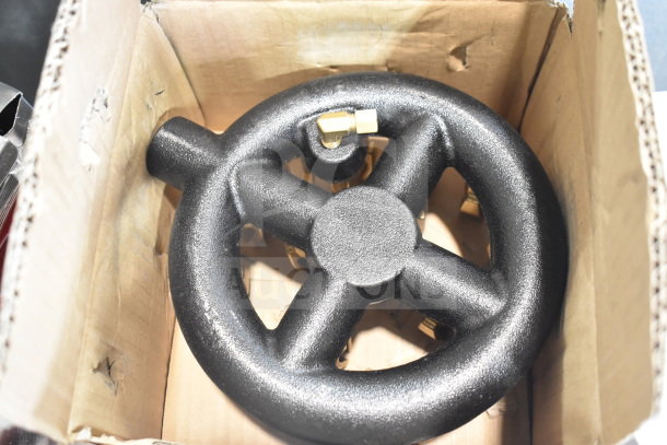Black burner component in cardboard box, new with minor cosmetic dents, suitable for hot plate or burner use.