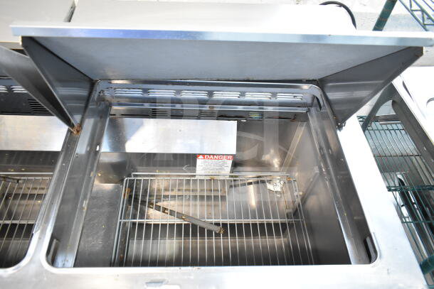2019 Delfield 4460NP-24M sandwich salad prep table, mega top, bain marie, 115 volts, 1 phase, open top showing interior.