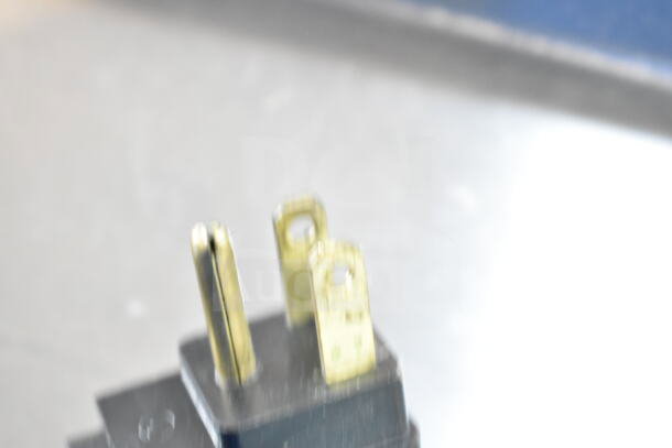 Close-up of a plug for the 2019 Delfield 4460NP-24M commercial sandwich salad prep table, 115 volts, 1 phase.