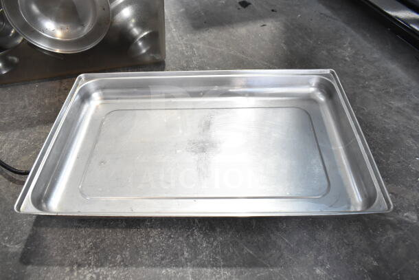 Lot of various metal items including a rectangular serving tray and chafer lids. Items show moderate wear.