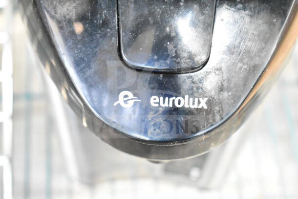 Eurolux black beverage dispenser, used, with visible logo. Part of a lot including Hamilton Beach beverage holder.
