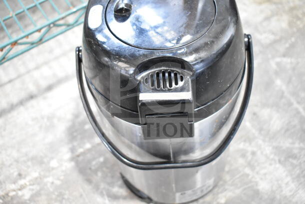 Hamilton Beach beverage holder dispenser, stainless steel exterior, black lid and handle, shows minor wear.