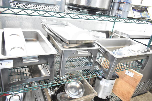 Four stainless steel chafing dishes on a wire rack, all in good condition with lids and fuel holders. Visible quantity label: "QTY x4".