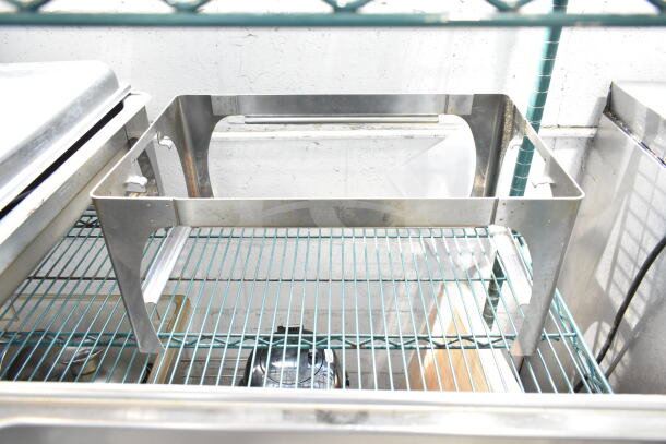 Four stainless steel chafing dishes, sturdy metal frames, and covers visible. Ideal for catering. Some wear is visible.