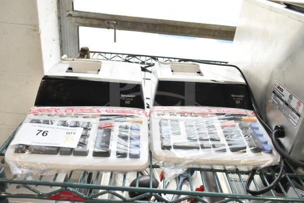 Pair of Sharp EL-1197PIII countertop printing calculators, new, wrapped in plastic, with bid label "76 QTY X2".