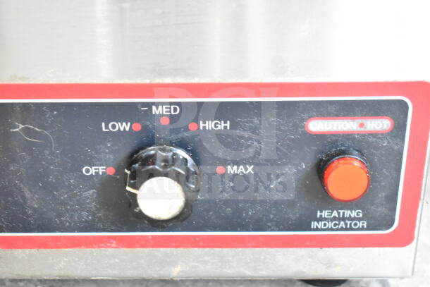 Winco FW-S500 countertop food warmer control panel with heat settings and caution label, indicating 120V operation.
