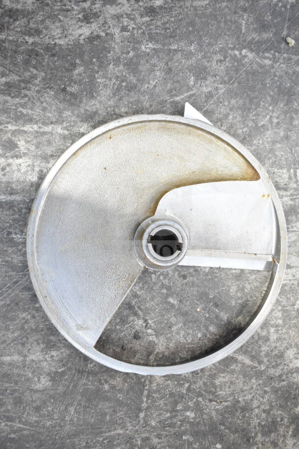 Metal disc blade, slightly tarnished, center hole for mounting. Part of "5 Various Blades" auction item.