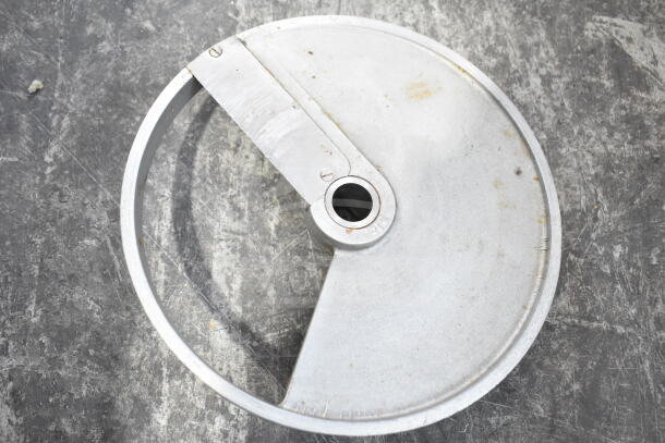 Alt text: Circular metal blade with central hole, visible wear, suitable for cutting machinery.
