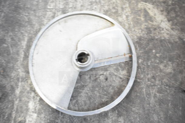 Circular metal blade with central mounting hole on a textured surface. Part of a set of five variable blades, auction item.