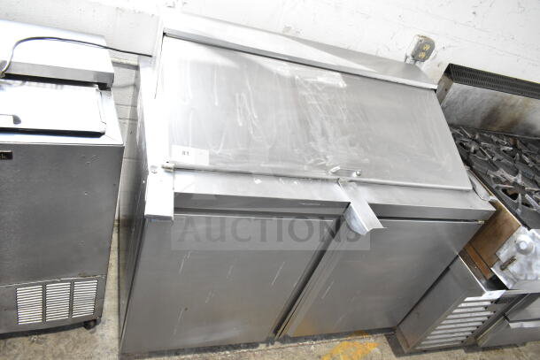 Delfield 4448NP-18M-A5 Commercial Sandwich Prep Table; stainless steel, two doors, 115V, in good condition.