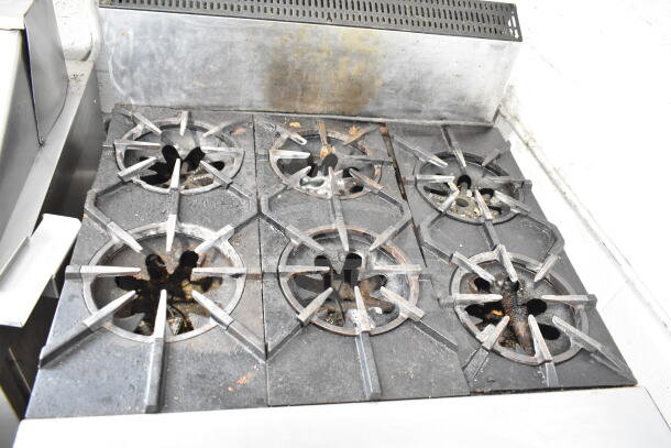 Garland Commercial 6-Burner Gas Range, countertop model, used condition with visible wear, ideal for robust cooking needs.