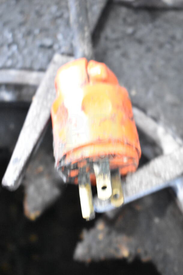 Blurred image of an orange electrical plug for a Traulsen Commercial 2 Drawer Chef Base, 115 volts, 1 phase.