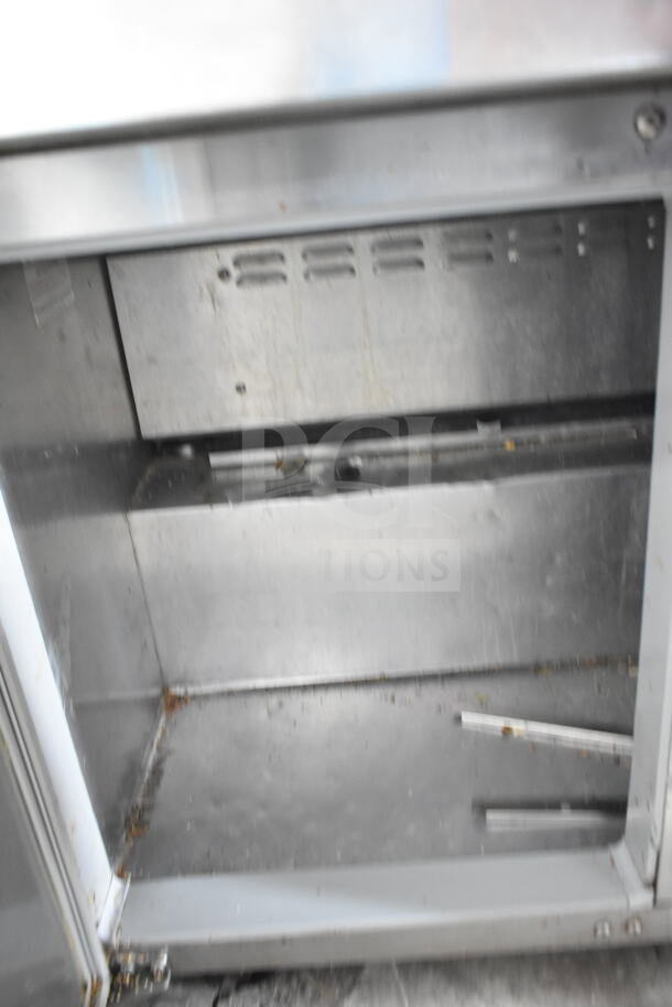 Continental SW48-12M commercial sandwich prep table interior, 115V, 1 Phase, stainless steel, visible wear, no labels shown.