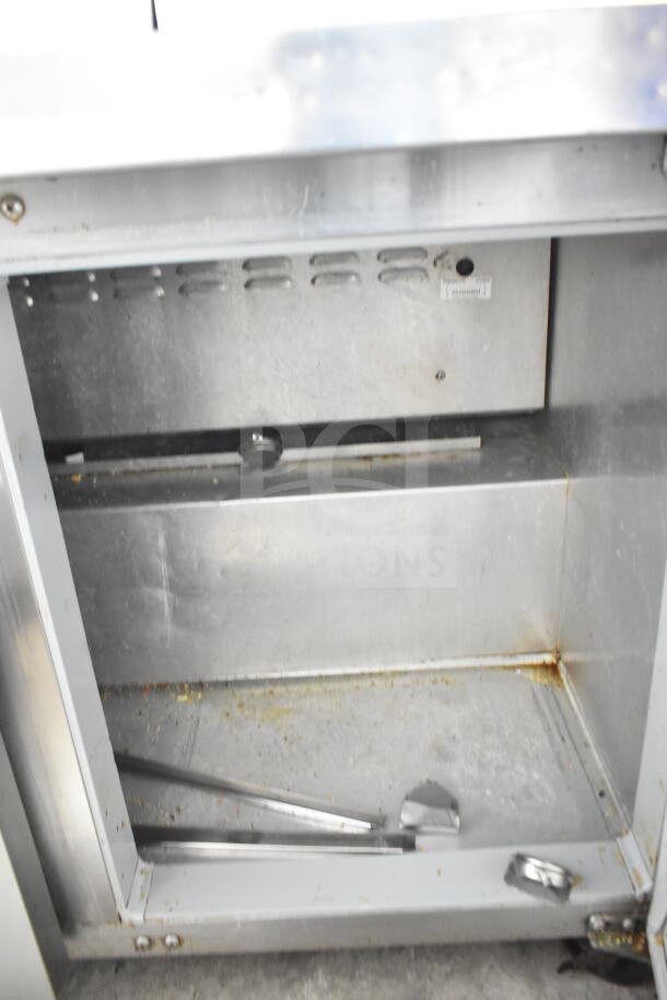 Continental SW48-12M commercial prep table interior showing signs of wear; features stainless steel construction and storage space.