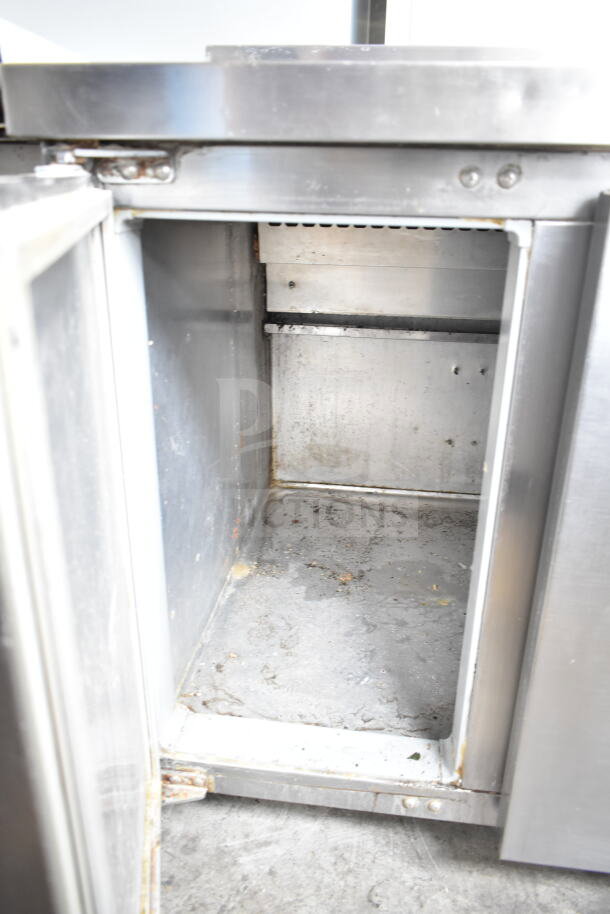 Continental CPA60 pizza prep table, 115V, 1 Phase. Stainless steel, interior view showing storage condition.