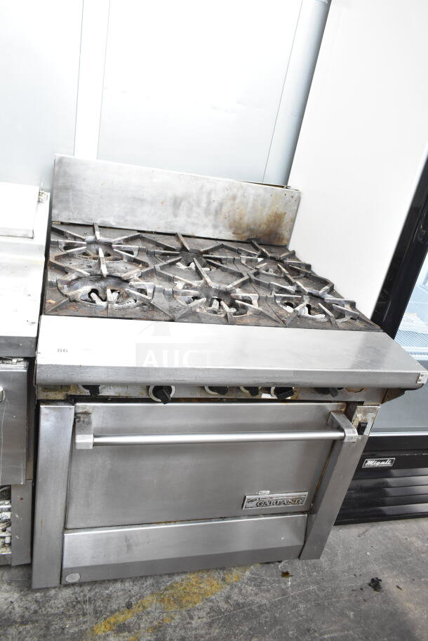 Garland commercial gas 6-burner range with convection oven. Features robust stainless steel build. Used condition.