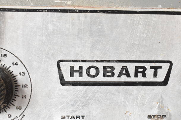 Hobart M 802 commercial dough mixer control panel with Hobart logo, speed dial, and metal surface details.