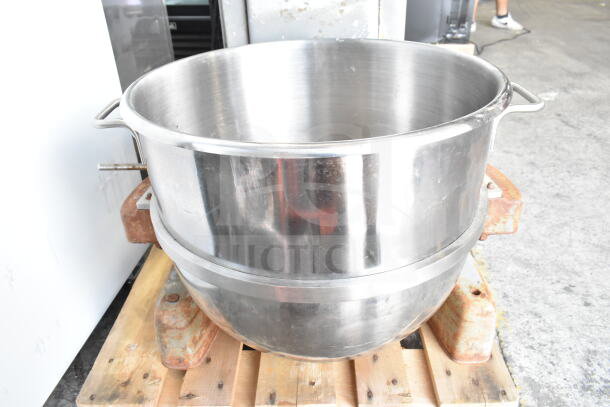 Hobart M 802 80-quart dough mixer bowl on dolly, stainless steel, visible wear, seated on a wooden pallet.