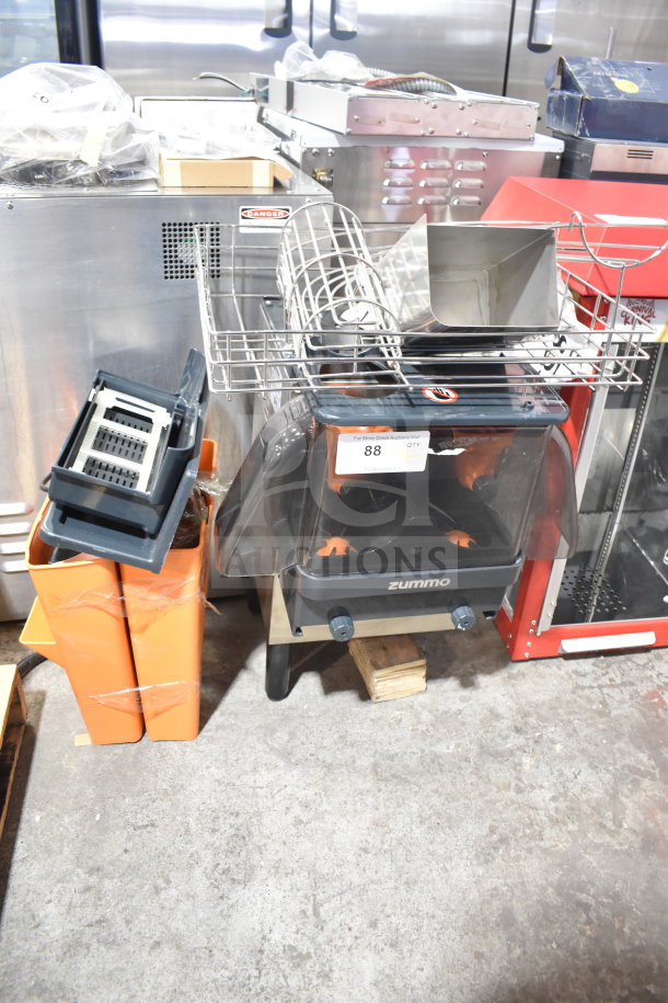 Zummo Z06C-N juicer, countertop model, visible brand marking, with orange waste bins, used condition, 100-120V, 1 Phase.