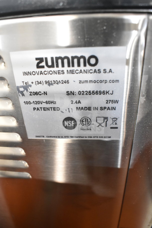 Zummo Z06C-N commercial juicer, stainless steel, 100-120V, 1 phase. Label shows serial number, NSF and ETL marks, made in Spain.