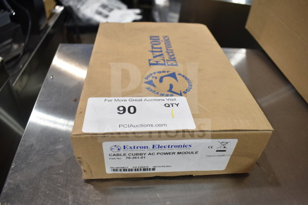 Extron 70-261-01 Cable Cubby AC Power Module in original packaging, labeled with Extron Electronics branding and part details.