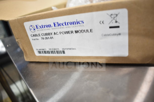 Extron 70-261-01 Cable Cubby AC Power Module, new in box. Label shows part number and manufacturing details.