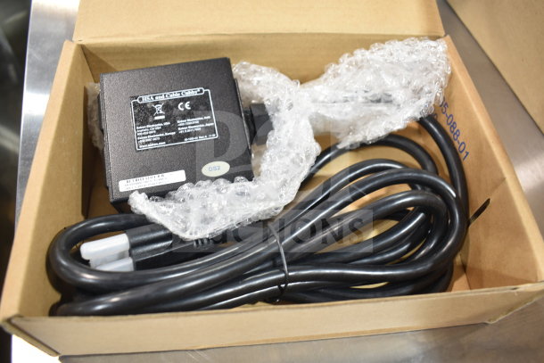 Extron 70-261-01 Cable Cubby AC Power Module in original box. Black unit with attached power cables. Visible labels: DS2, manufacturer details.