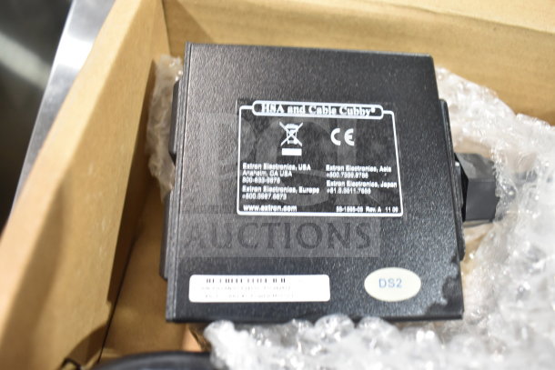Extron 70-261-01 Cable Cubby AC Power Module in box, with visible labels indicating model and compliance markings.
