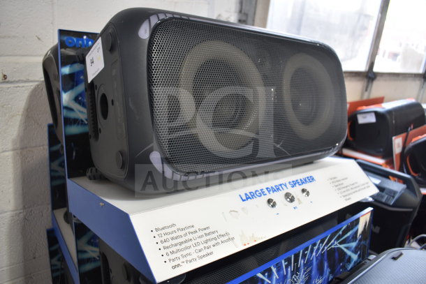 Onn large party speaker display, Bluetooth, 12-hour playtime, 640W peak power, rechargeable, LED lighting effects.