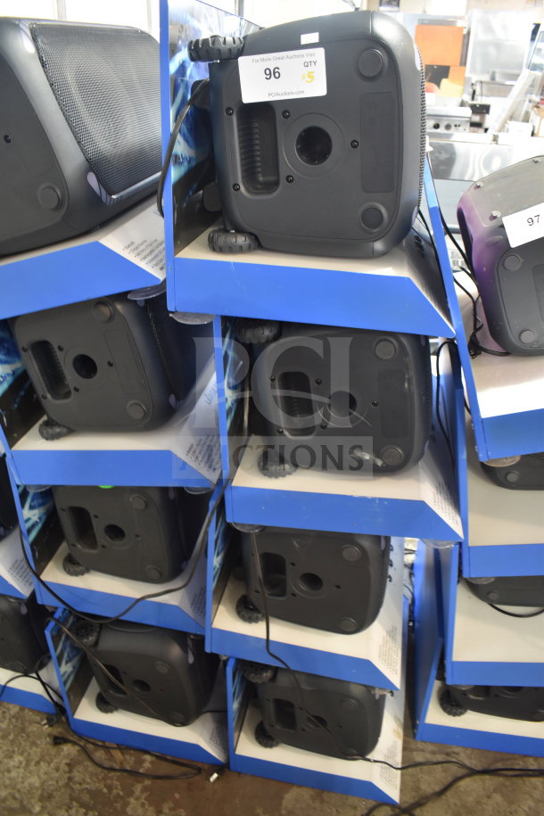Alt text: "5 Onn large party speakers on store display shelves, each new and boxed. Label indicates '96 QTY x5' for auction lot."