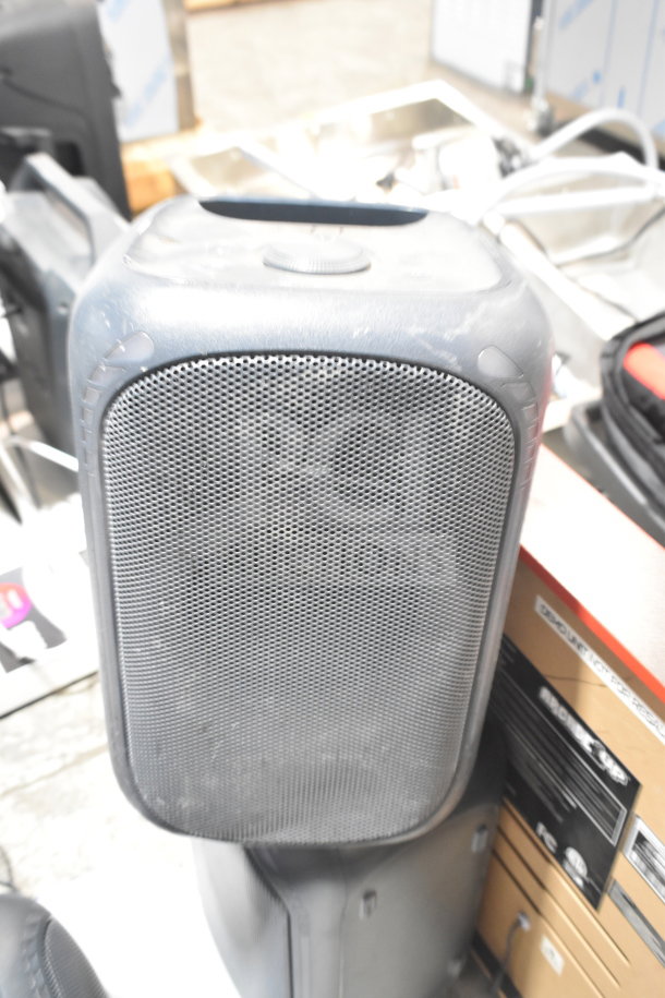 Onn medium party speaker in fair condition, black with mesh grille, part of a store display auction bundle.