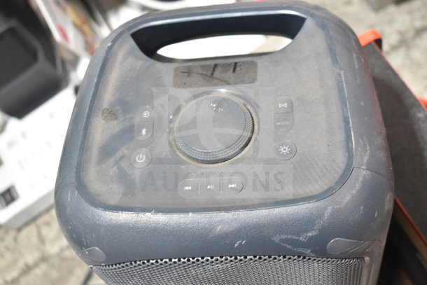 Onn medium party speaker with control panel. Visible dust and scuffs indicate previous use. Handle on top for portability.