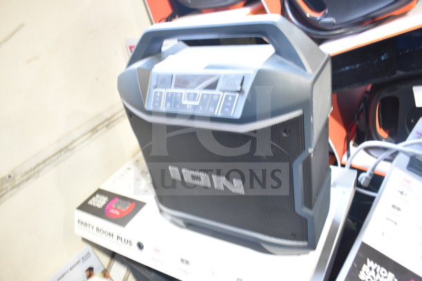 Ion Party Boom Plus speaker on display, brand name visible. Black, portable design with control buttons on top.