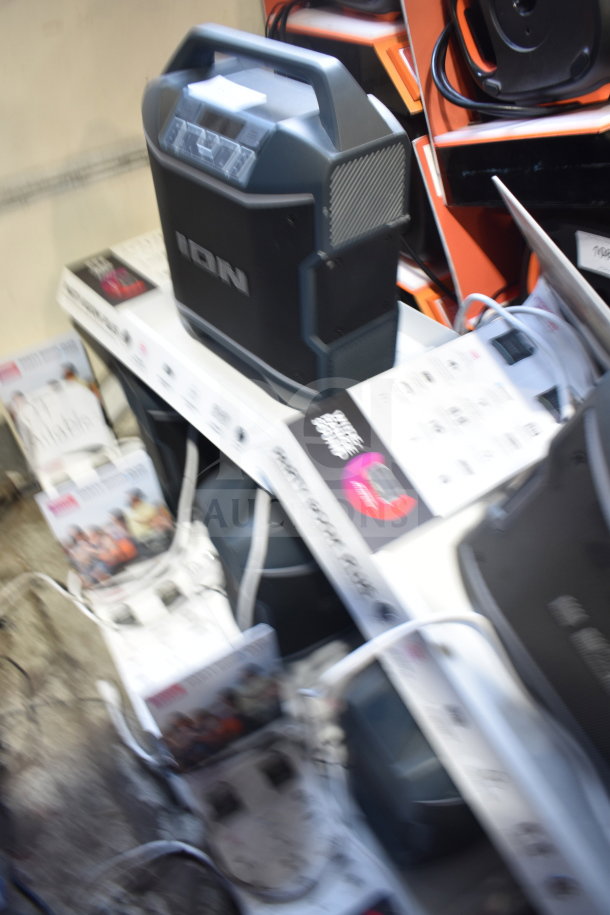4 Ion Party Boom Plus speakers in display. Features include large handle, control panel, and visible branding. Used condition.