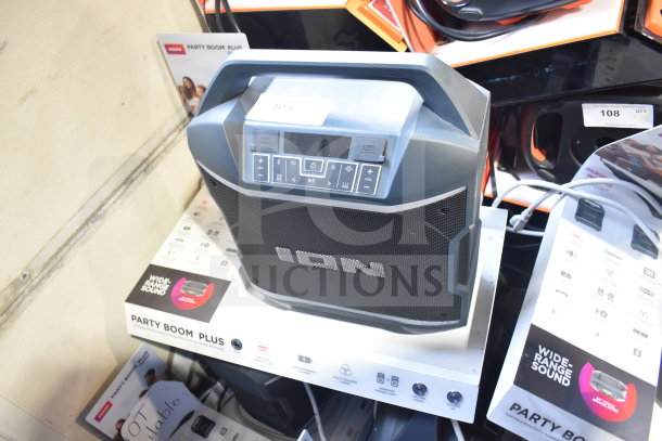 Ion Party Boom Plus speaker on store display, features include Bluetooth, USB port, and wide-range sound.