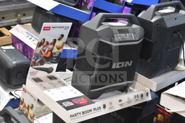 ION Party Boom Plus speaker display, three units showcased. Features Bluetooth connectivity, microphone included.