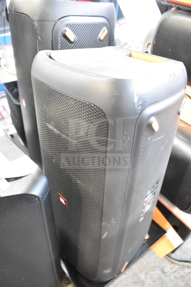 JBL store display speakers, black finish, used condition, with visible scuff marks and prominent JBL logo.