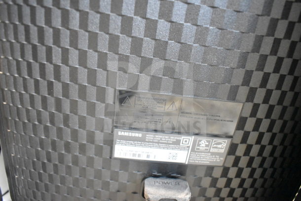 Samsung MX-ST4CB speaker close-up showing textured design and labels with model details and power button.