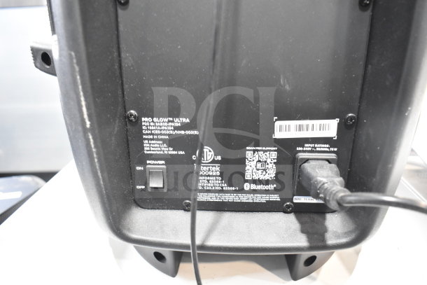 Pro Glow Ultra Speaker with visible power switch, cable input, Bluetooth support, and manufacturer details on back panel.