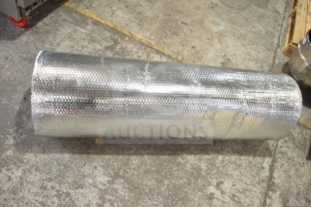 A large roll of silver bubble wrap insulation packaging, in good condition, lying on a concrete floor.