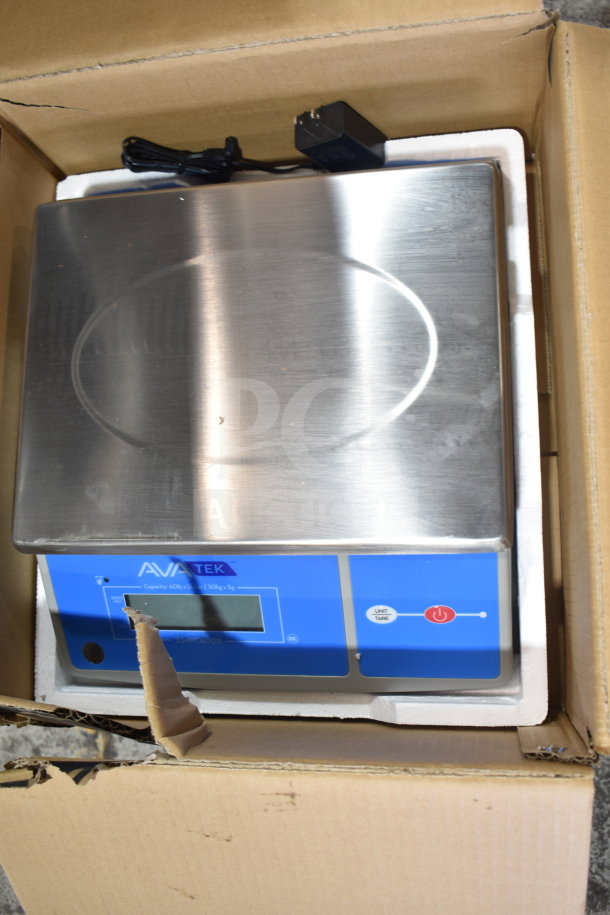 Brand new AvaTek 334PC60OS 60 lb. digital portion control scale with oversized platform in box, minor scratches visible.