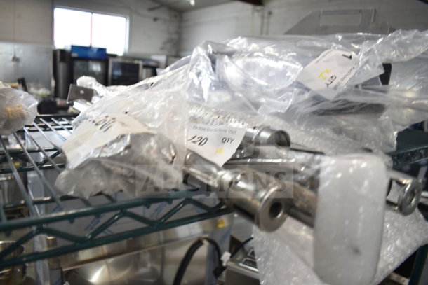 Four brand new scratch and dent items including Vulcan and Southbend parts, packaged with visible labels on metal shelving.