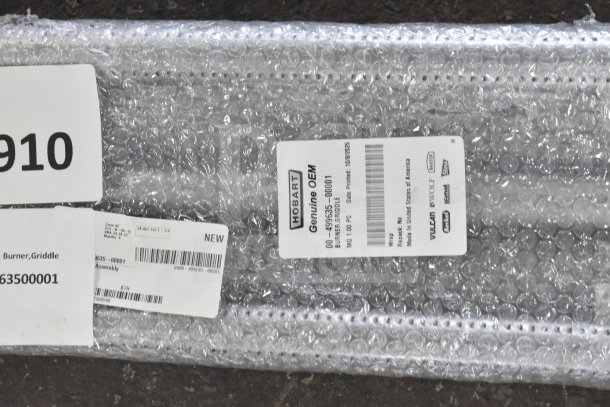 4 new items wrapped in bubble wrap, including Vulcan burner, Southbend door stop, Southbend burner assembly, and Backyard Pro grinder auger. Labels indicate item codes and "NEW" status.